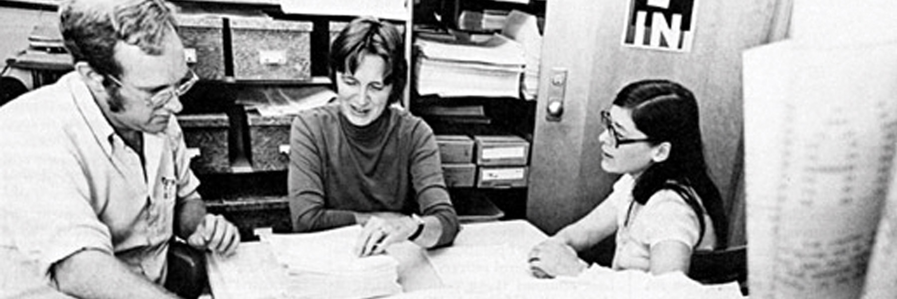 An archival image of three researchers, two women and one man.